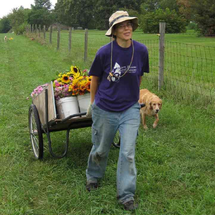 Teresa Brockman pulling a cart full of flowers at Sunny Lane Farm