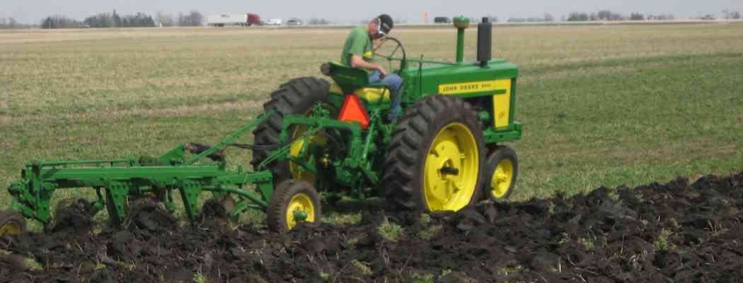 Tractor plowing in organically farmed field of the family's Brockman's farmland